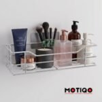 Wall-mounted chrome shower caddy filled with skincare products, lotion dispensers, and makeup brushes
