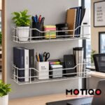 Two chrome wall-mounted wire shelves holding office supplies, books, stationery, and a potted plant