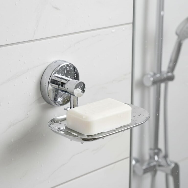 Chrome wall-mounted soap dish holding a bar of white soap on a tiled shower wall