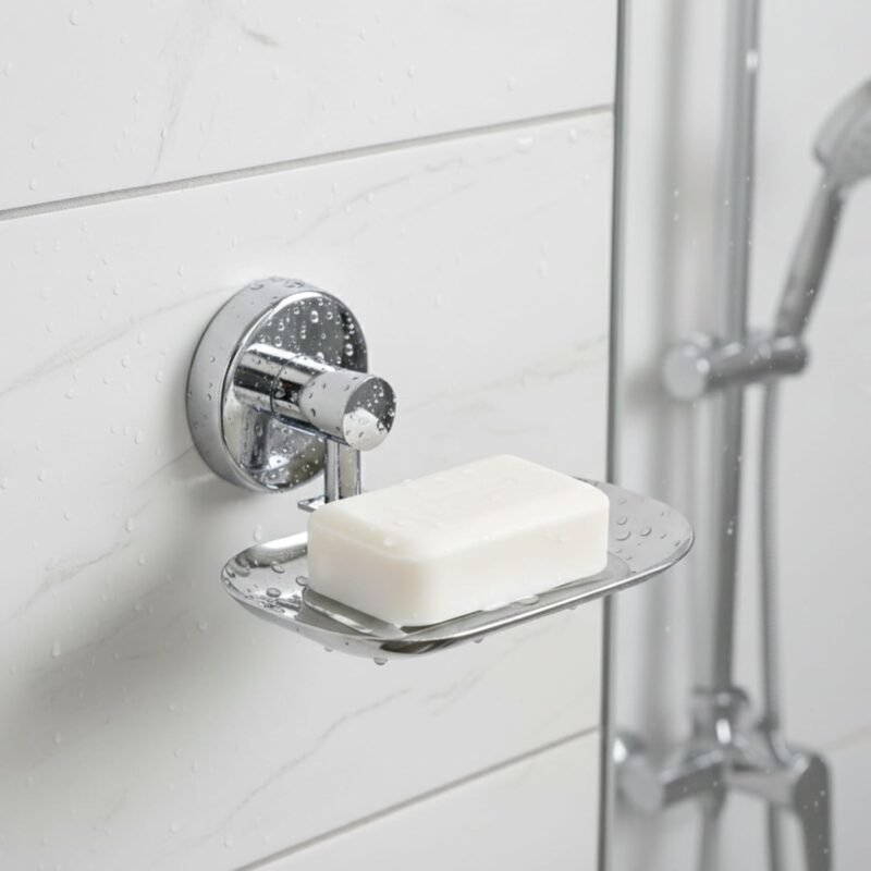 Chrome wall-mounted soap dish holding a bar of white soap on a tiled shower wall